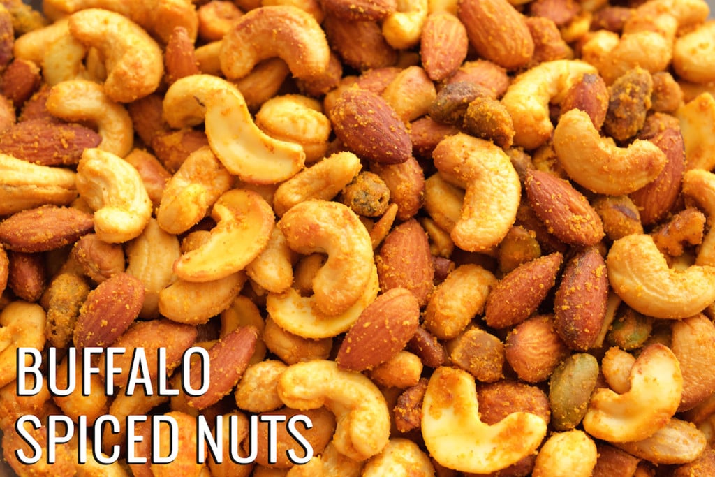 Close up of homemade buffalo flavored nuts. Text in the bottom left corner reads "Buffalo Spiced Nuts".