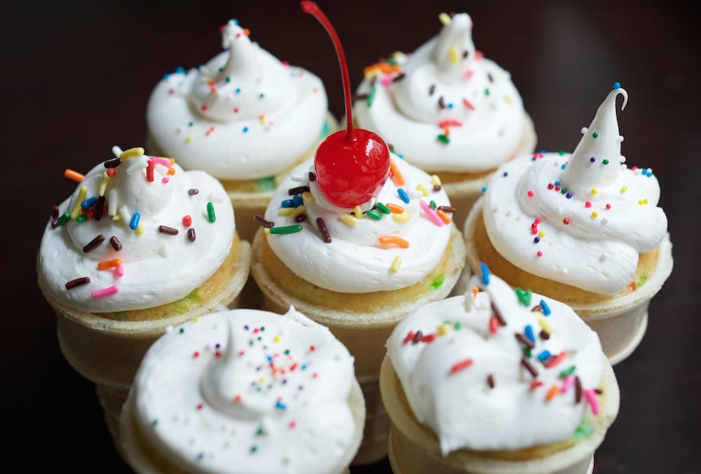 Ice Cream Cone Cupcakes with sprinkles and a cherry on top.