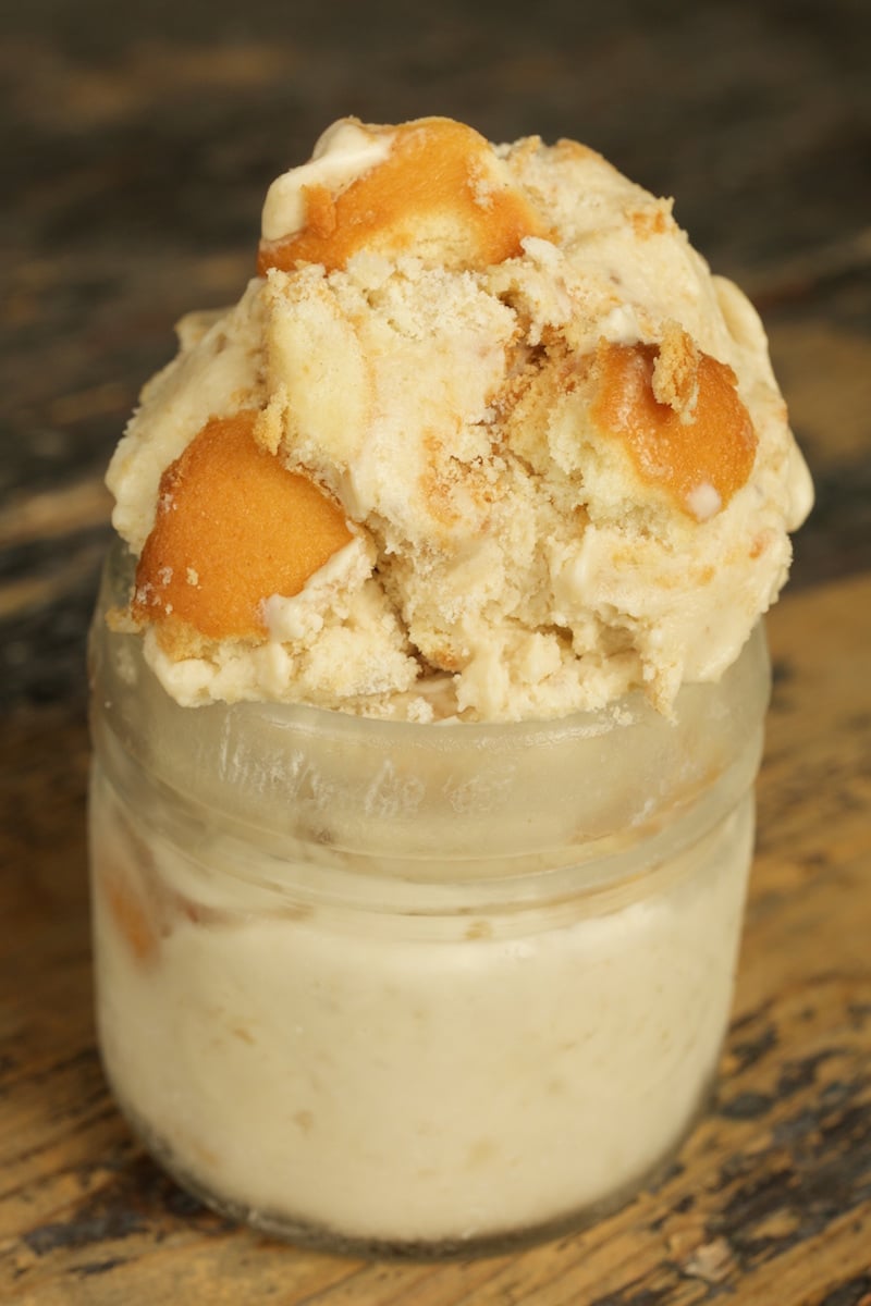 A glass jar overflowing with scooped Banana Pudding Ice Cream.