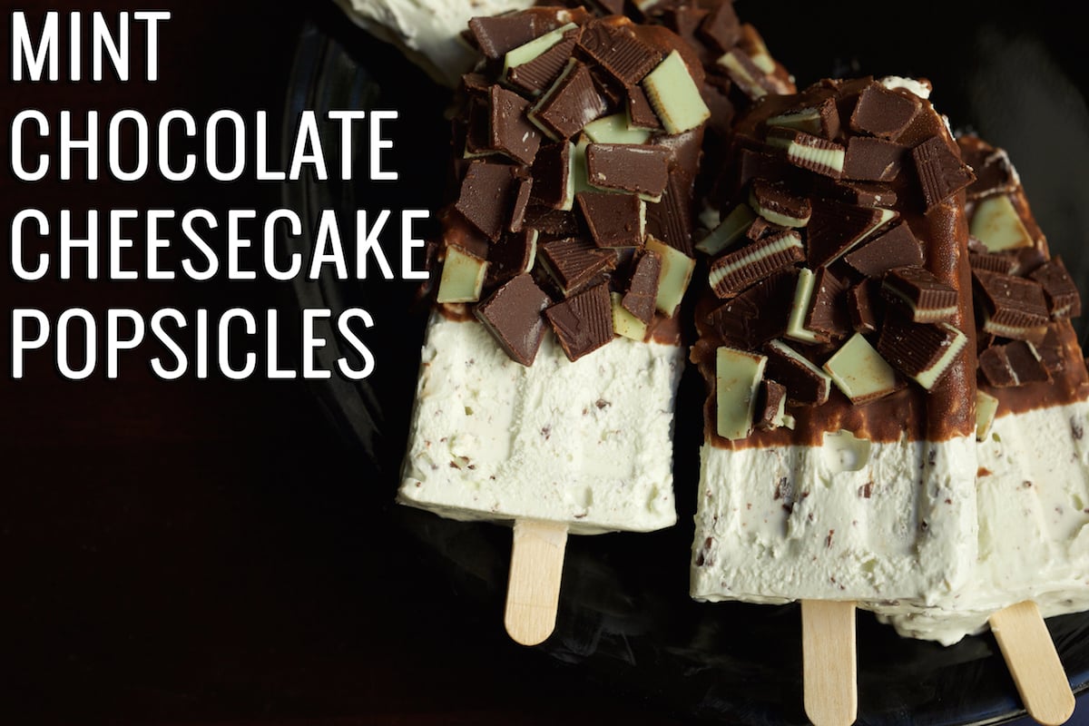 Three mint chocolate cheesecake popsicles on a black background. The text in the top left corner reads "Mint Chocolate Cheesecake Popsicles"