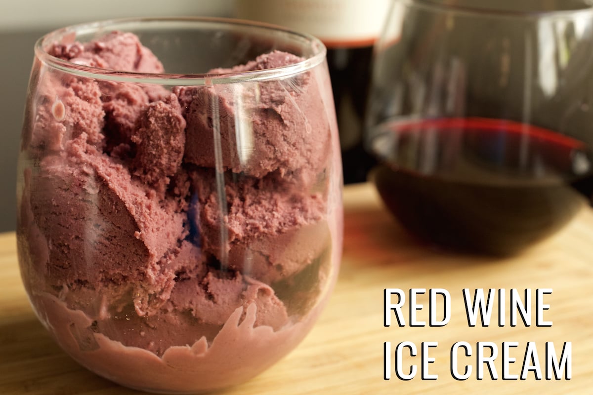 A stemless wine glass is filled with wine ice cream in front of one filled with red wine. Text in the lower right hand corner reads "Red Wine Ice Cream".
