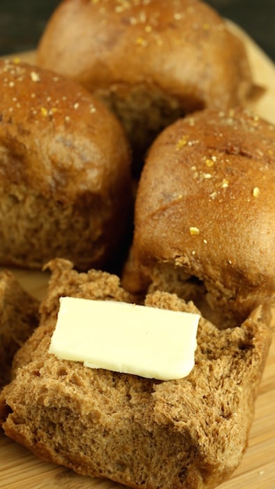 An Outback Steakhouse Roll cut open with a pat of butter placed inside.