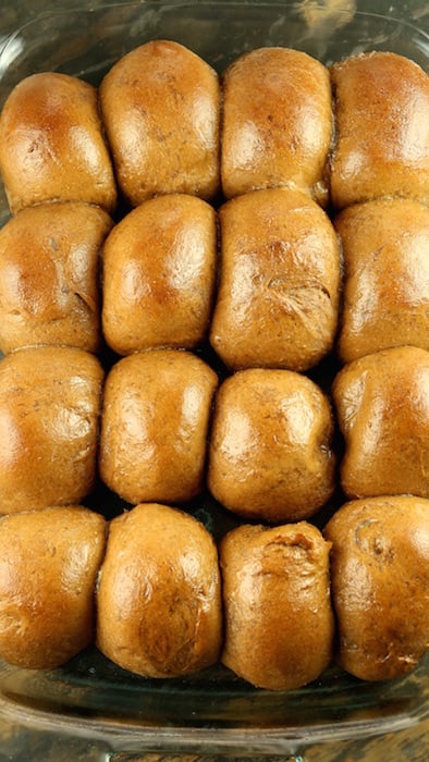 Cooked brown Outback Steakhouse Rolls in a glass pan.