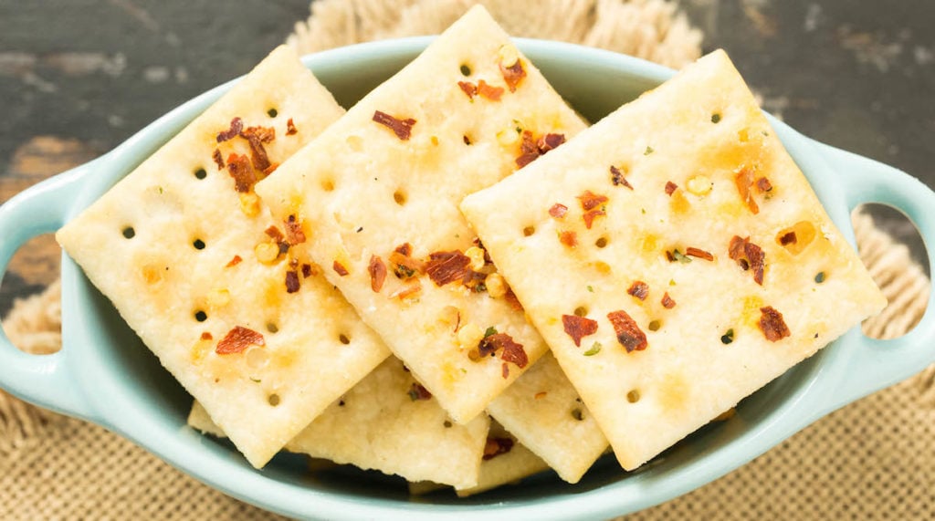 "Fire Crackers" (Saltine crackers seasoned with ranch and red pepper flakes) sit in a small oval serving dish.