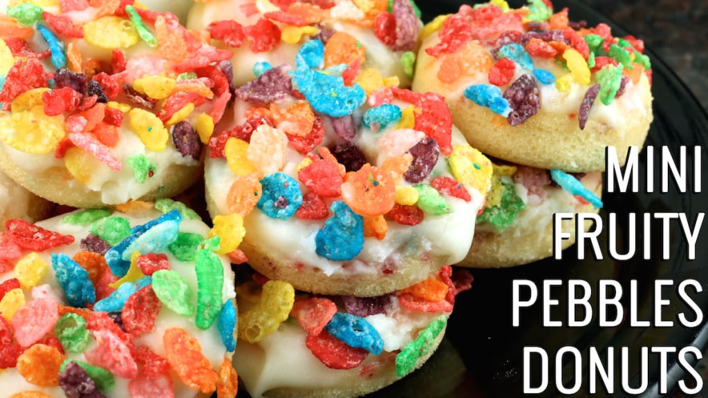 Close up of Mini Fruity Pebbles Donuts stacked on top of each other.