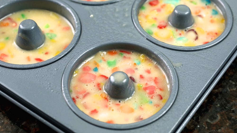 Mini Fruity Pebbles Donut batter in a mini donut pan.