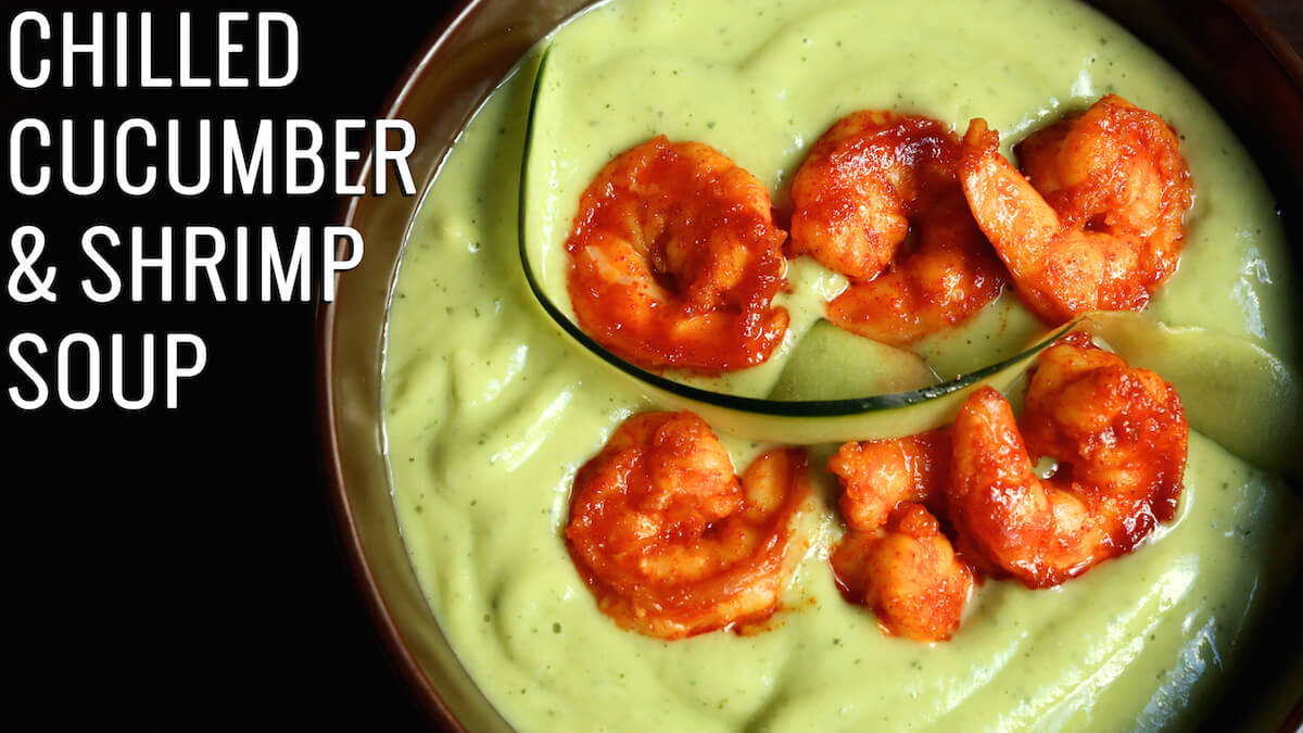 A cold green soup with shrimp covered in red sauce on top. Text reads "Chilled Cucumber & Shrimp Soup"
