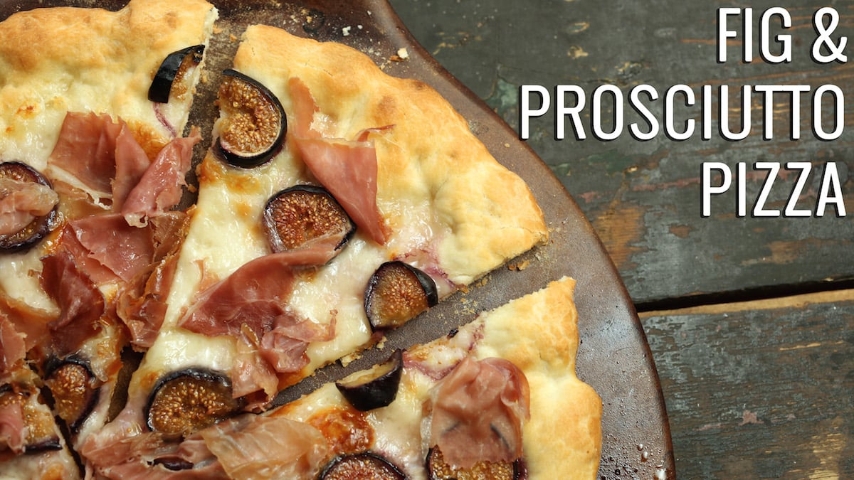 A sliced pizza sits on a pizza stone. Text reads "Fig and Prosciutto Pizza"