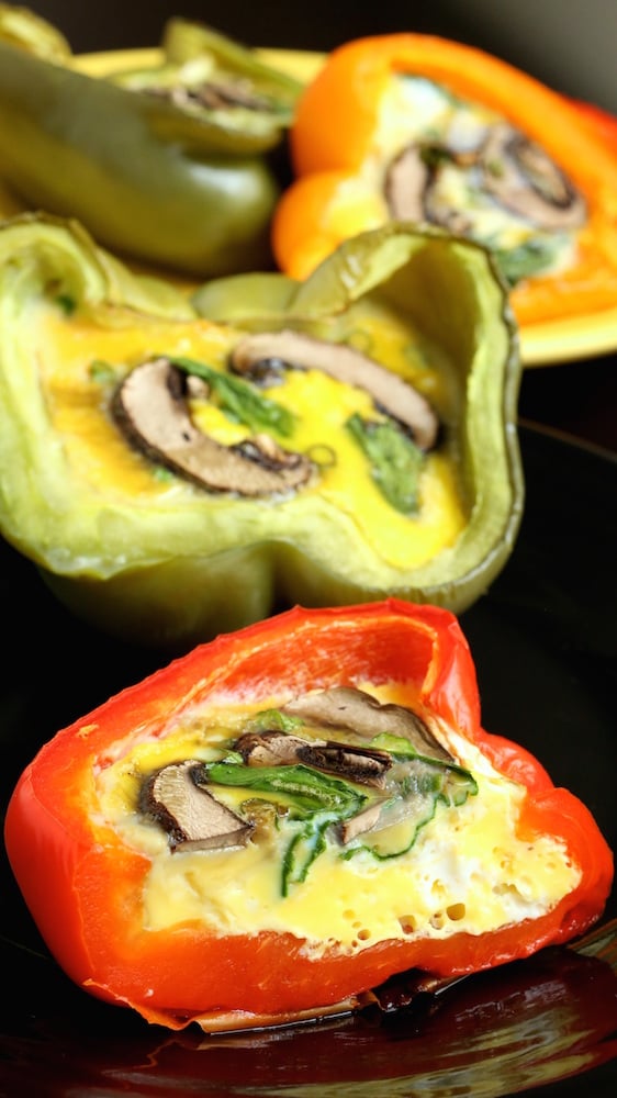 Spinach, Mushroom, & Egg Stuffed Bell Peppers on a black plate