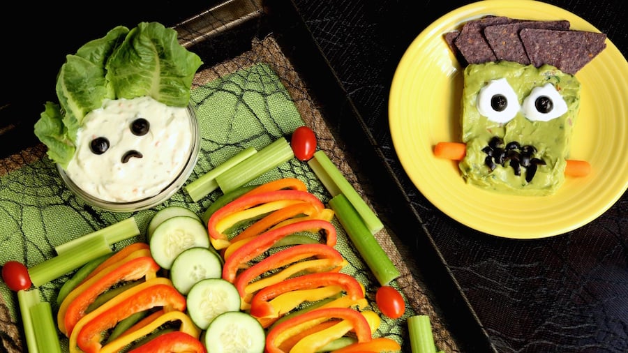 Halloween Skeleton Veggie Tray next to Frankenstein Guacamole.