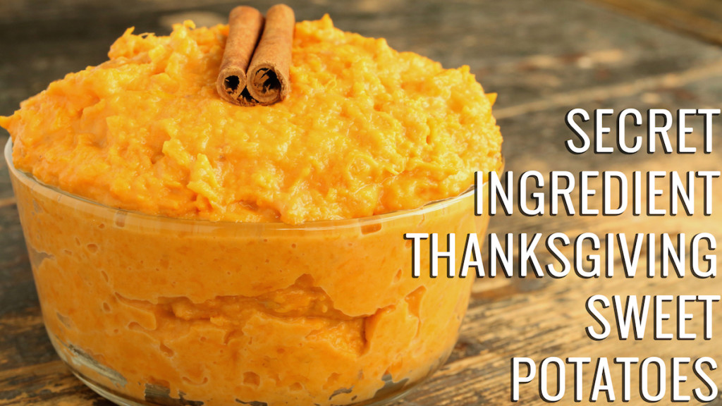 A clear serving bowl filled with sweet potato mash and garnished with a cinnamon stick. Text reads "Secret Ingredient Thanksgiving Sweet Potatoes"