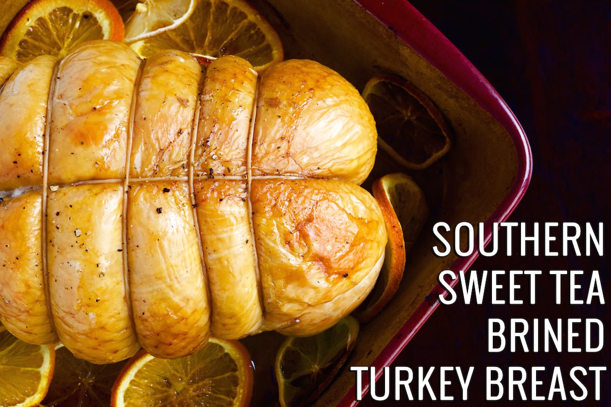 Sweet Tea Brined Turkey Breast in a small baking dish surrounded by sliced citrus.