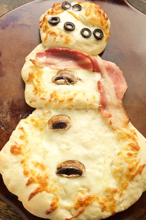 Cooked Snowman Pizza on a pizza stone