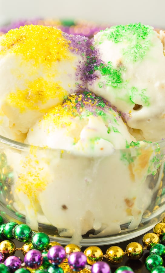 King Cake Ice Cream in a glass bowl surrounded by Mardi Gras beads