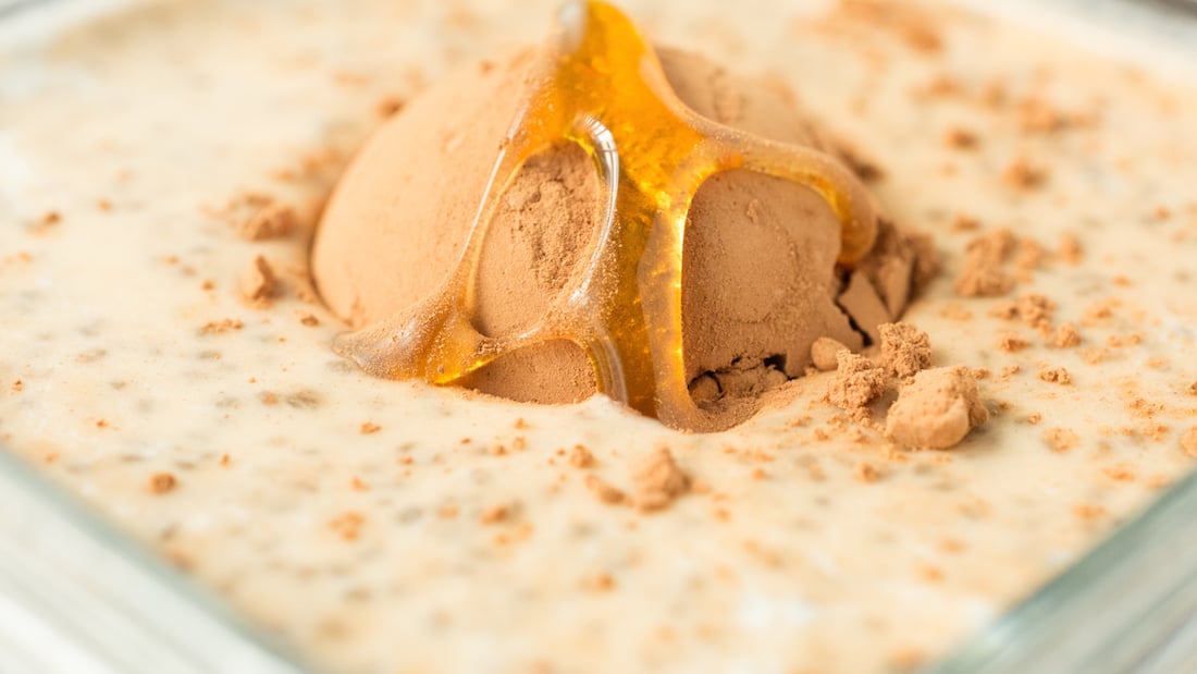 An extreme close up of the ingredients for banana cacao chia pudding before being mixed. 