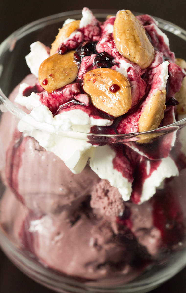 Red Wine Ice Cream Sundae with Vanilla Bean Whipped Cream, Spiced Red Wine Syrup, and Lavender Almonds.