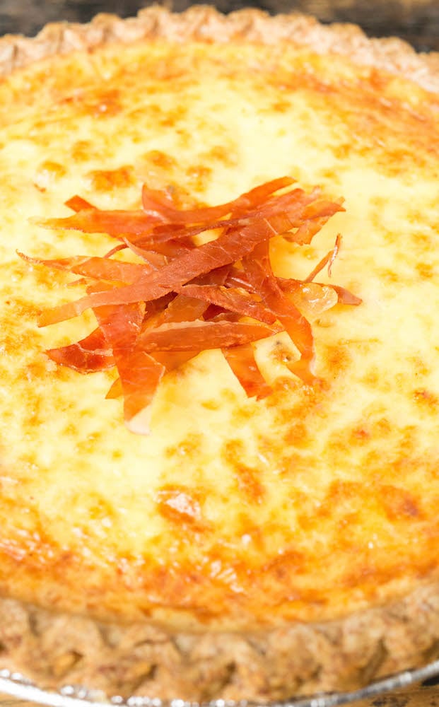 Crispy prosciutto slices on top of duck egg quiche.