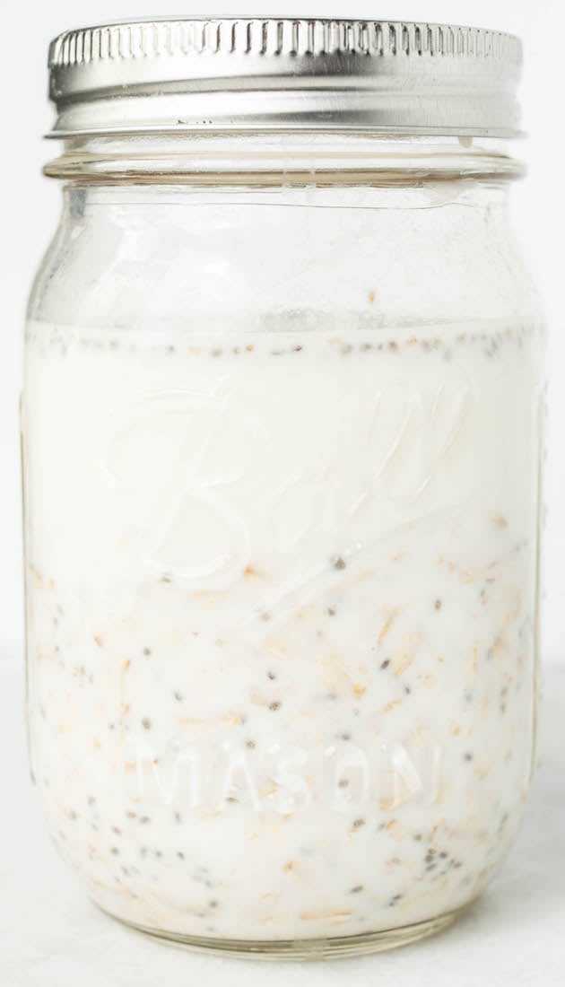 The vanilla overnight oats in a mason jar on a white background.