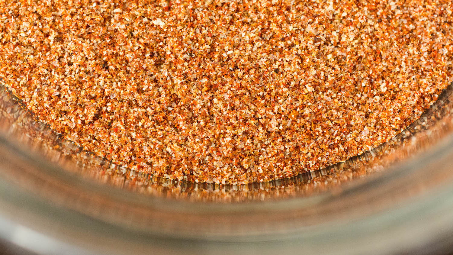 Extreme close up of a fajita seasoning blend in a glass bowl.