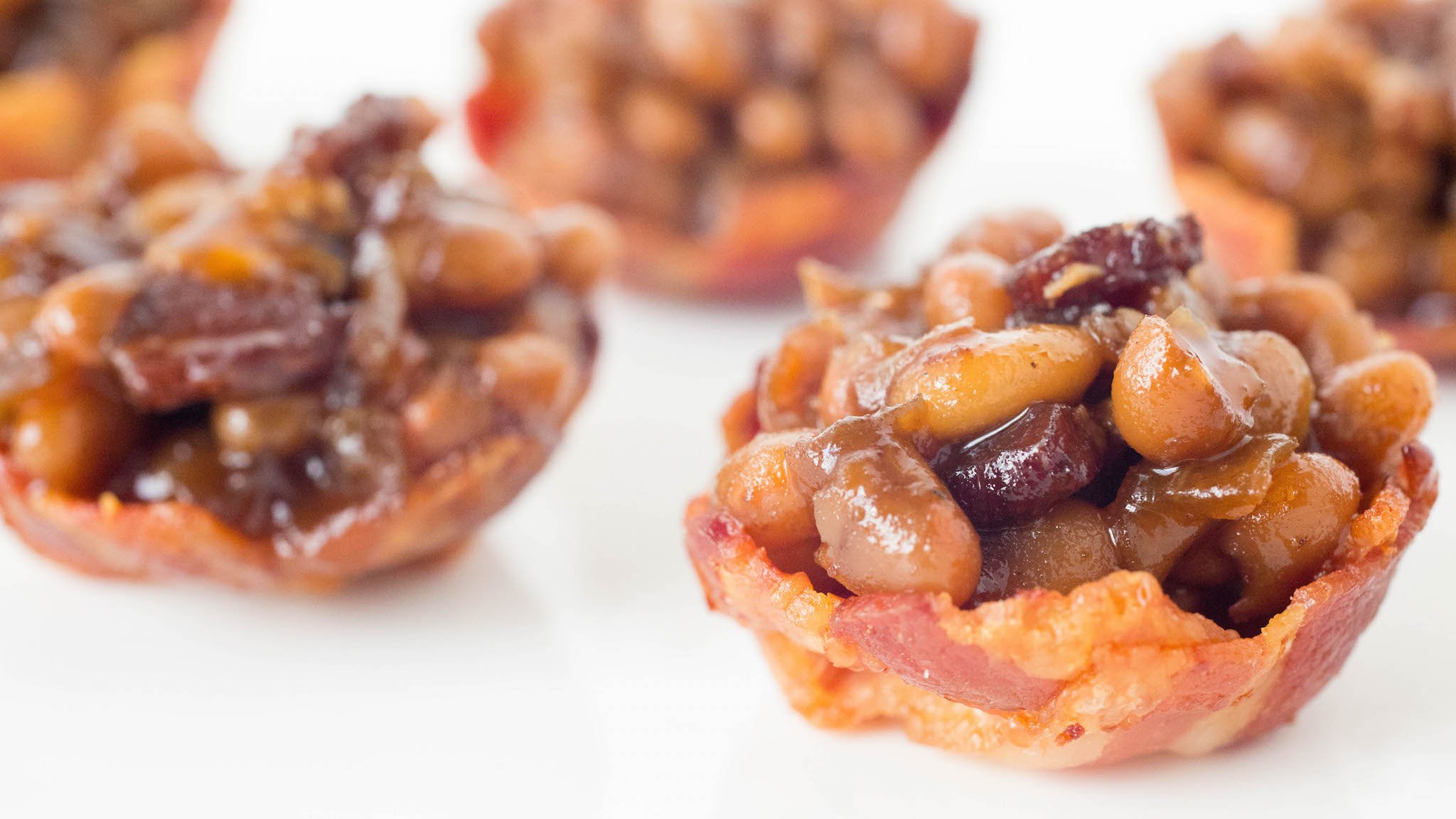 Bacon has been cooked into the shape on miniature bowls and filled with baked beans.