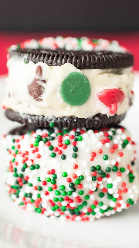 Close up of two Christmas Cookie Dough stuffed Oreos stacked on top of each other.