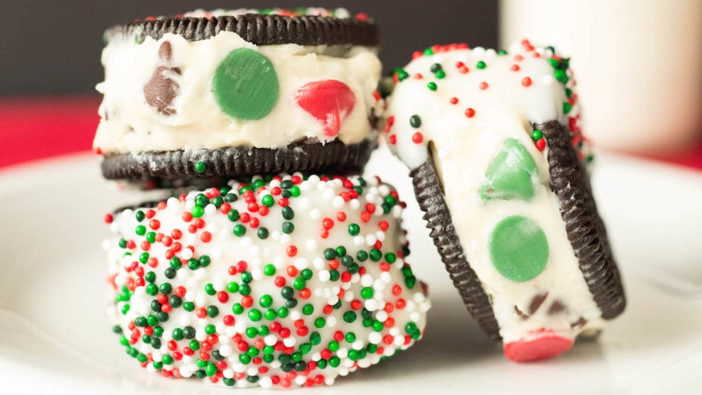 Oreos stuffed with Christmas cookie dough, then dipped in white chocolate and sprinkles.