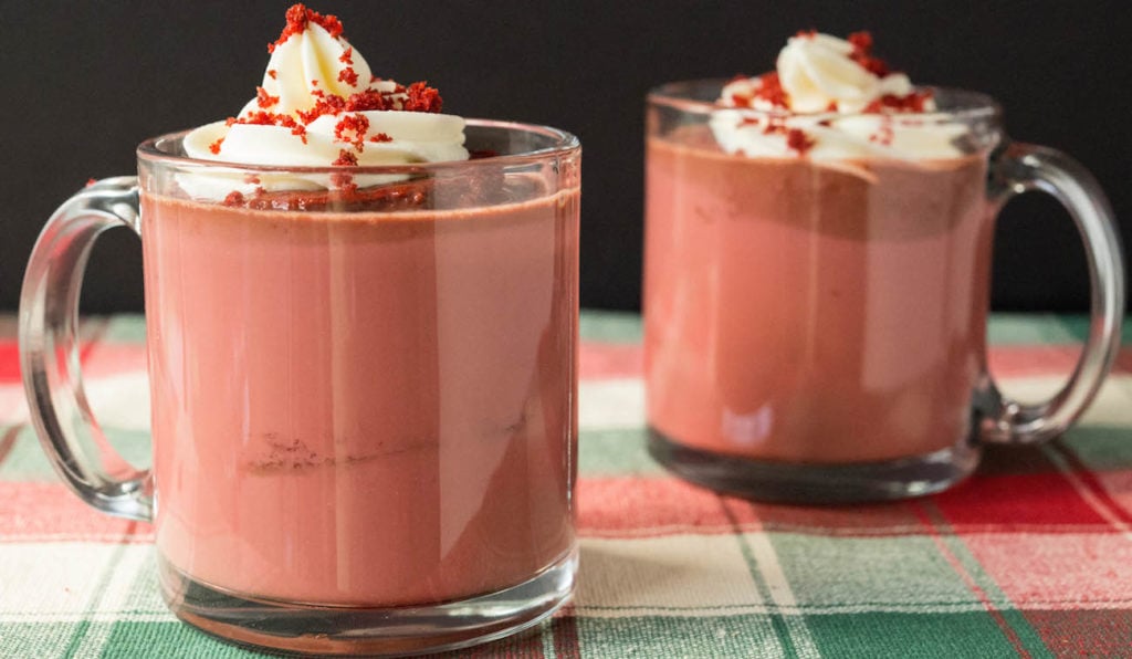 Two cups of Red Velvet Hot Chocolate recipe with Cream Cheese Whipped Cream.