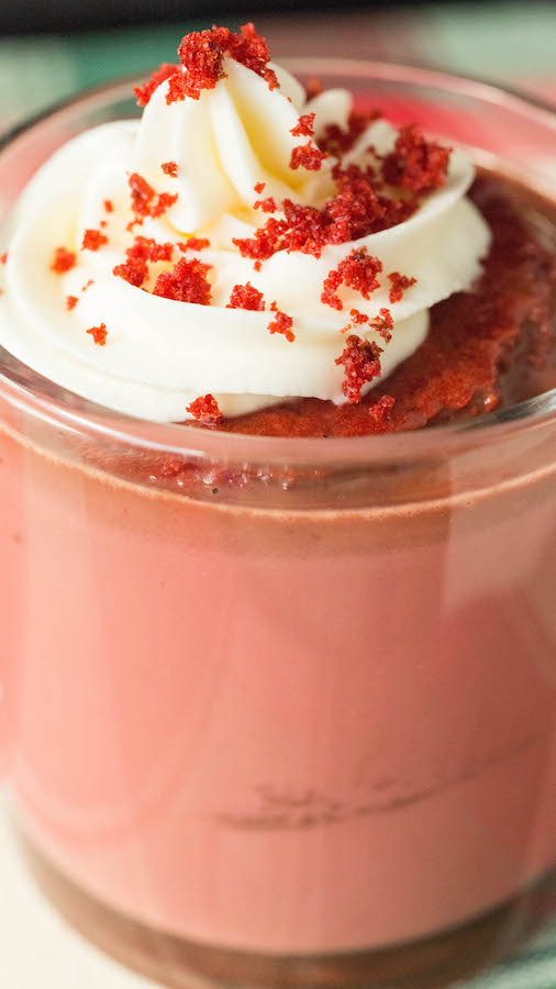 Close up of cream cheese whipped cream on a red velvet hot chocolate.