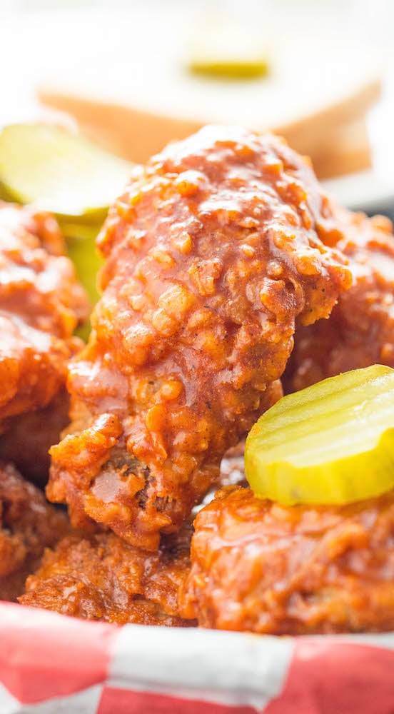 Nashville Hot Fried Chicken Drumstick next to a pickle slice.