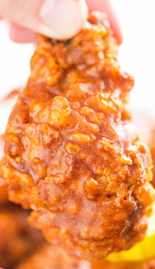 Sauce dripping from a Nashville Hot Fried chicken wing.