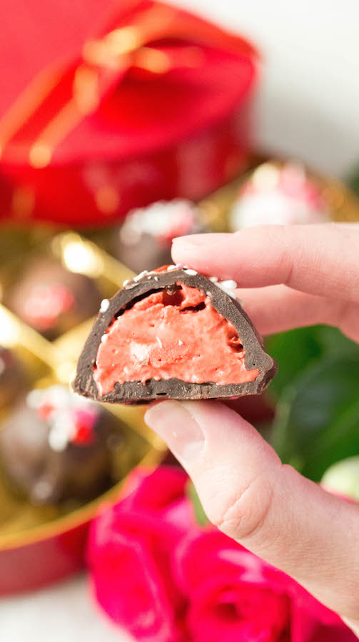Close up of an Ice Cream Truffle that has been sliced in half to show the red velvet gelato inside.