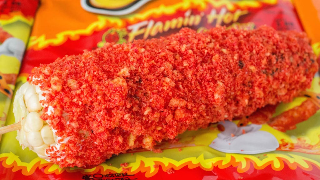 Flamin' Hot Cheetos Mexican Street Corn on top of bags of the chips.