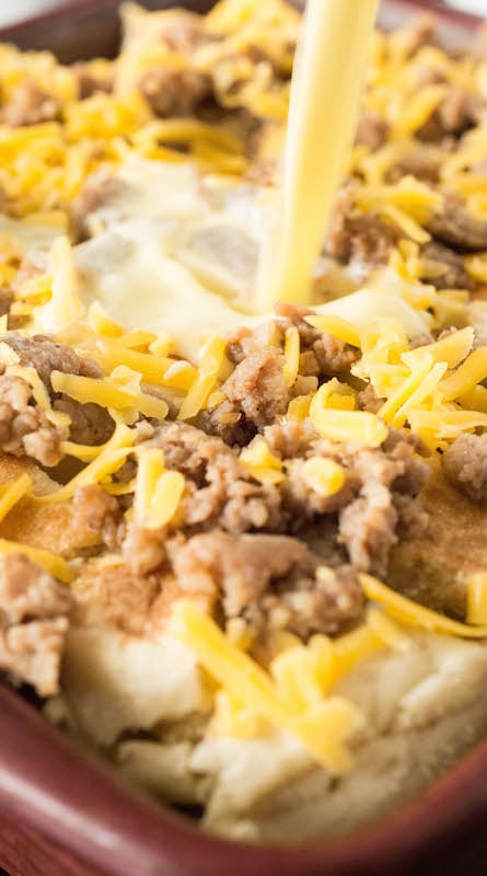 The egg mixture being poured over the top of the McMuffin Casserole.