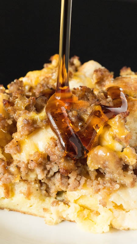 Maple syrup being poured over a slice of Egg McMuffin casserole.