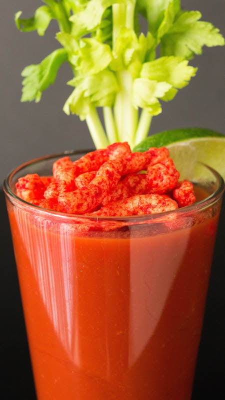 Flamin' Hot Cheetos Bloody Mary with Flamin' Hot Cheetos on top.