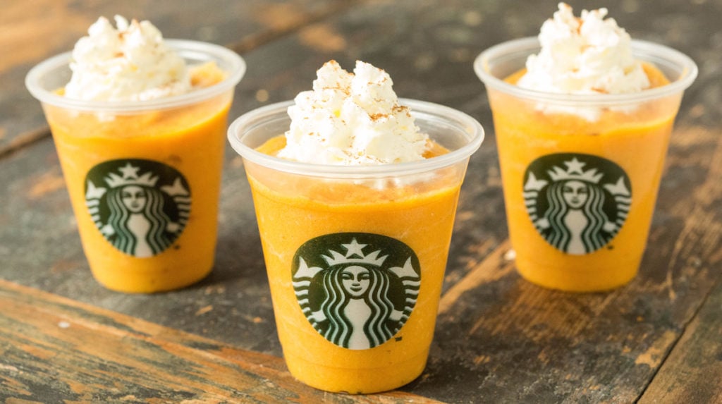 Three Pumpkin Spice Lattes for dogs in mini Starbucks cups.