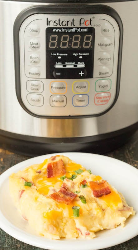 A slice of twice baked potato casserole sitting in front of the Instant Pot.