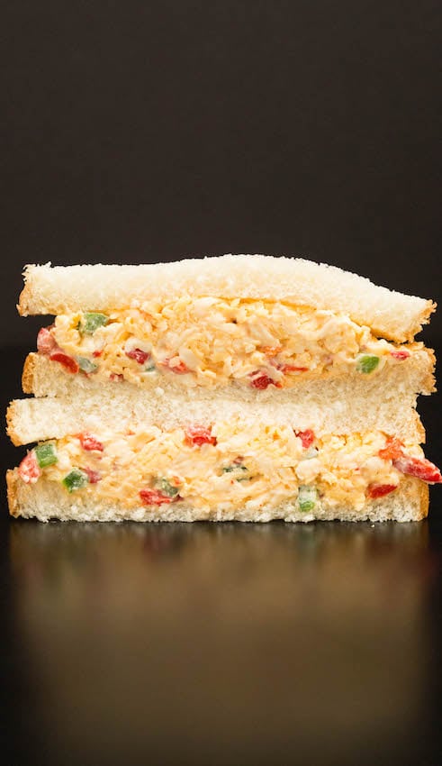 A sandwich made with white bread and homemade pimento cheese.