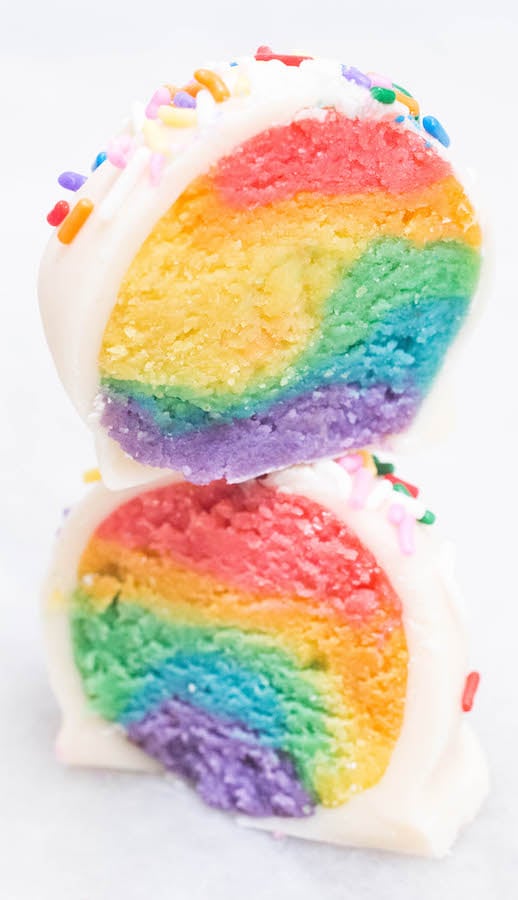 A Rainbow Cake Truffle sliced in half and stacked on top of each other.