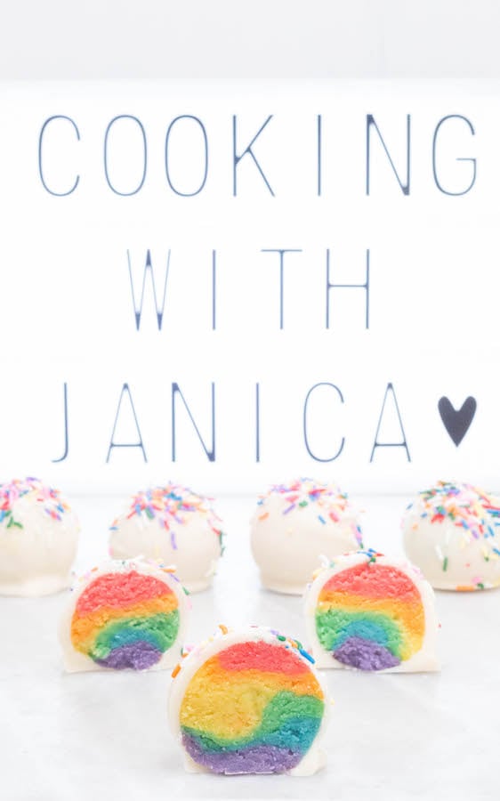 Seven Rainbow Cake Truffles in front of a sign that reads "Cooking with Janica".