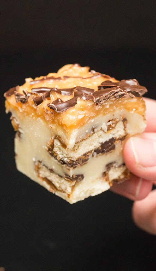 A hand holds a piece of Samoa Girl Scout Cookie Fudge.