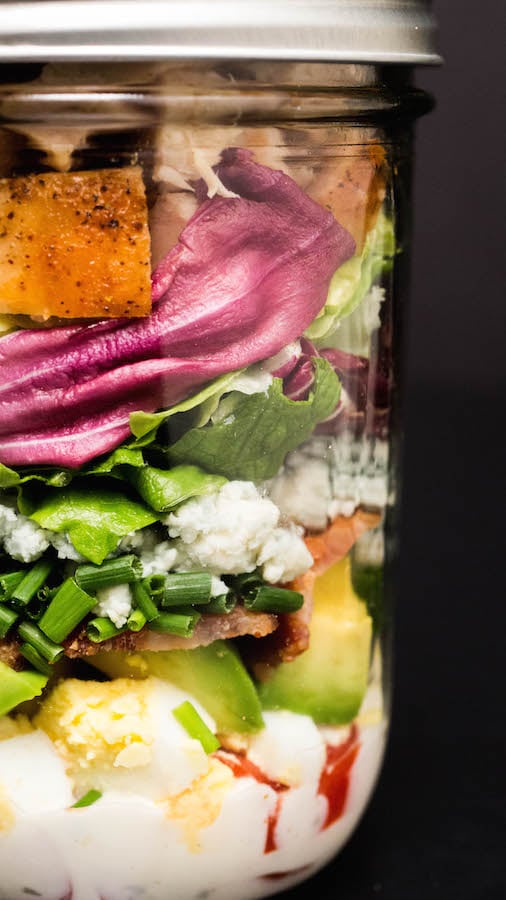 Close up of the layers of a Mason Jar Cobb Salad.