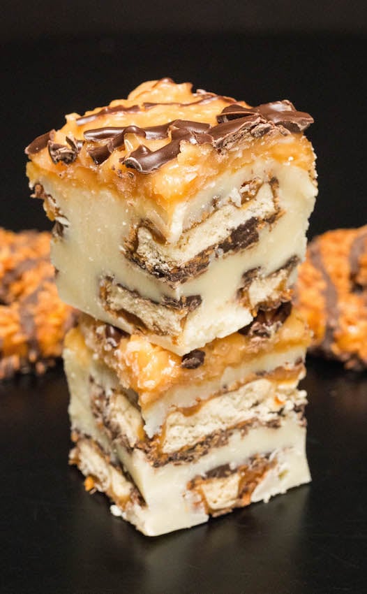 Two pieces of Samoa Cookie Fudge stacked on top of one another.