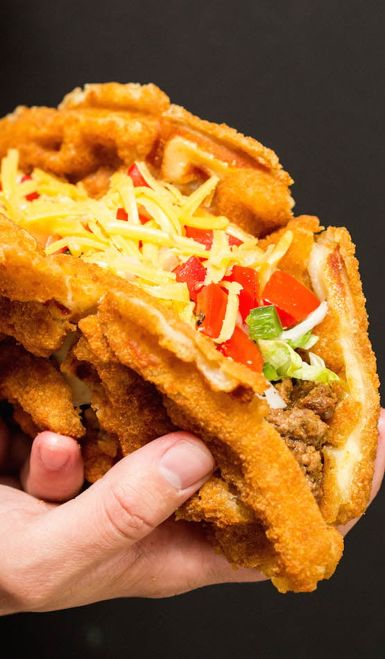 A large taco with a shell made of out waffle sticks cooked in the waffle maker.