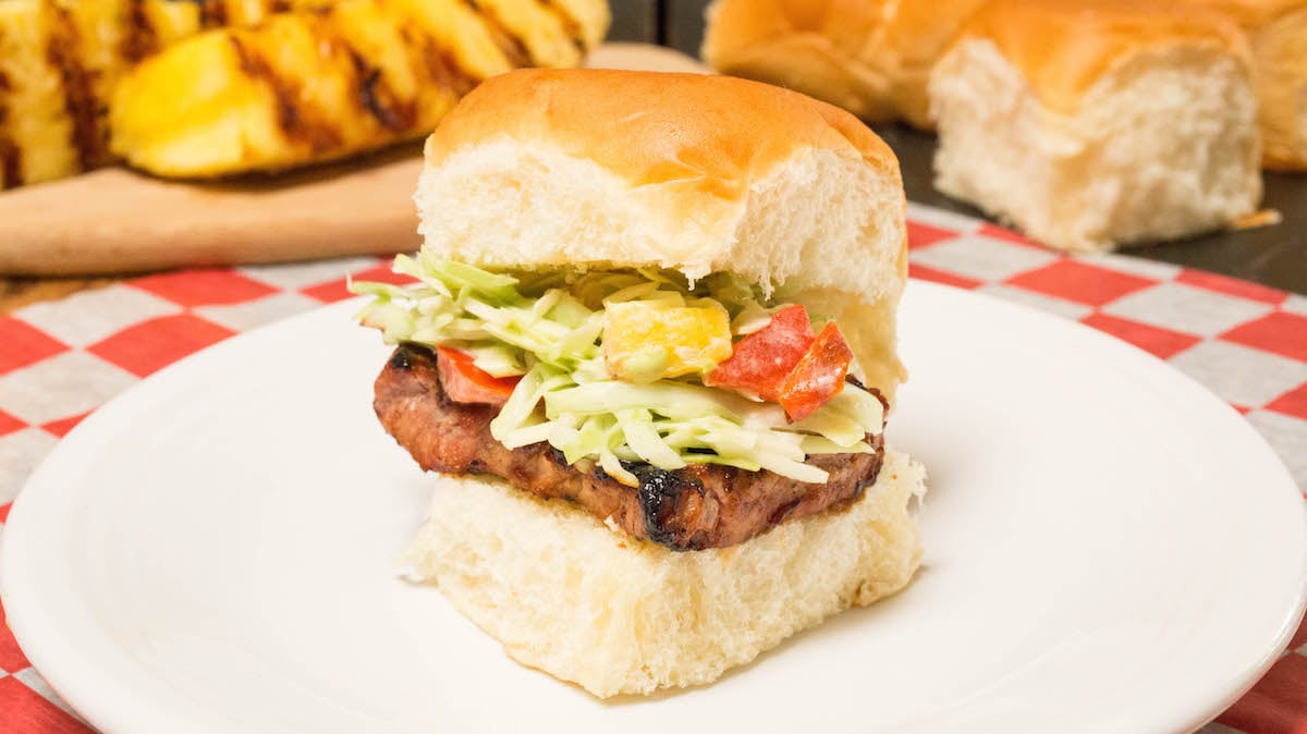 A Hawaiian roll slider with grilled pork tenderloin and tropical slaw.