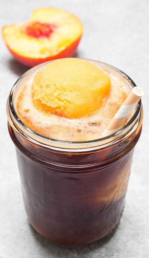 A mason jar containing Sweet Tea with a scoop of Peach Sorbet Ice Cream.