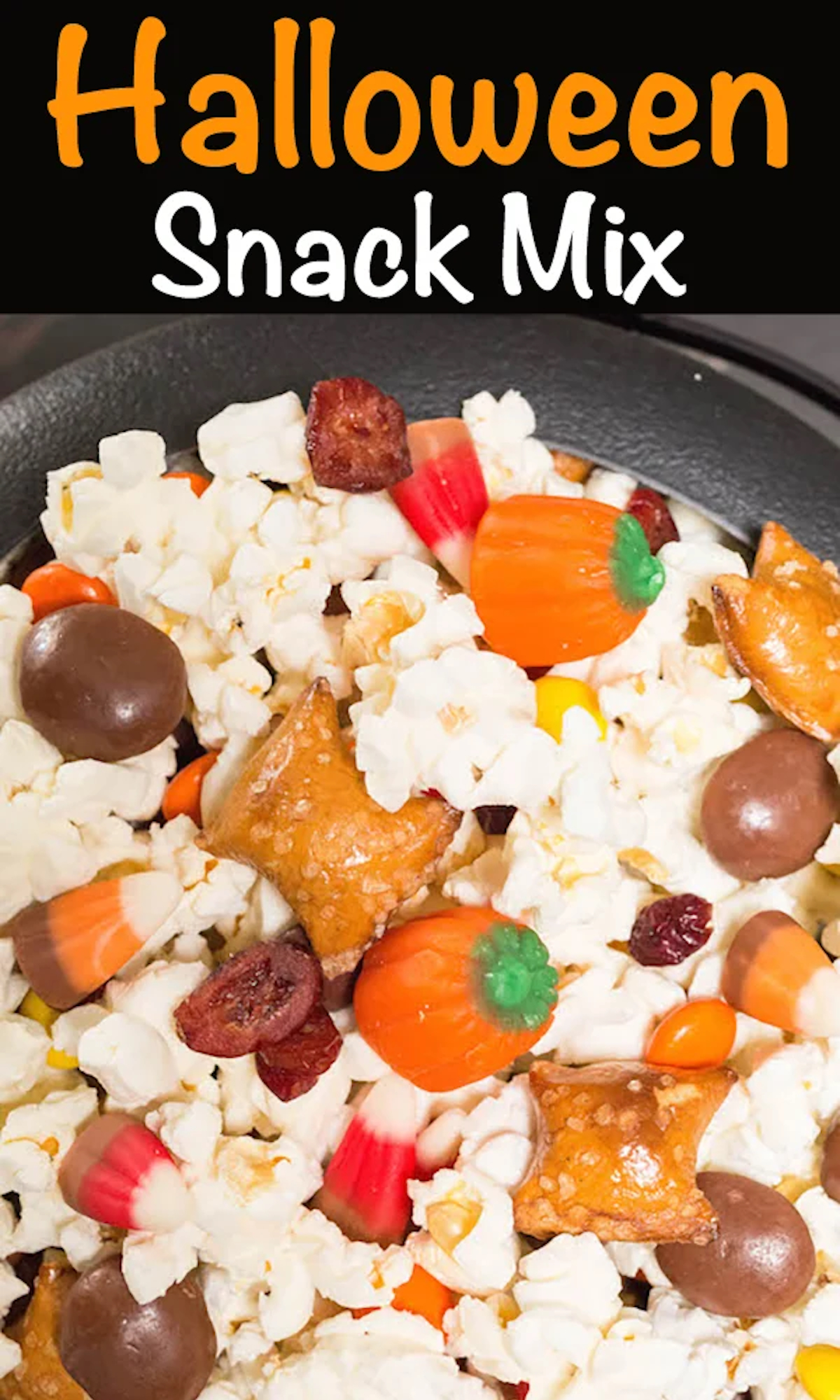 Close up of popcorn and fall candies, text at the top reads "Halloween Snack Mix".