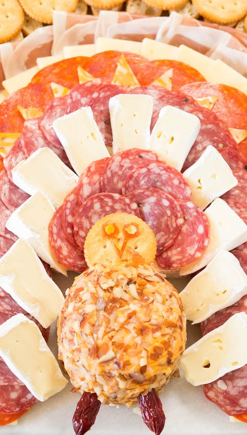 Cheese ball, ritz cracker, and sliced meats and cheeses made to look like a turkey.