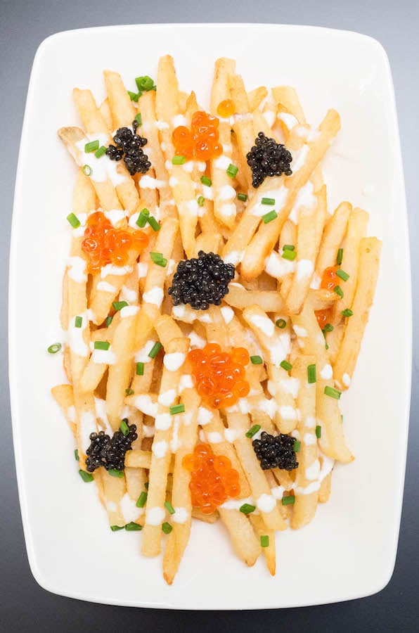 Overhead view of Caviar Fries on a white serving plate.