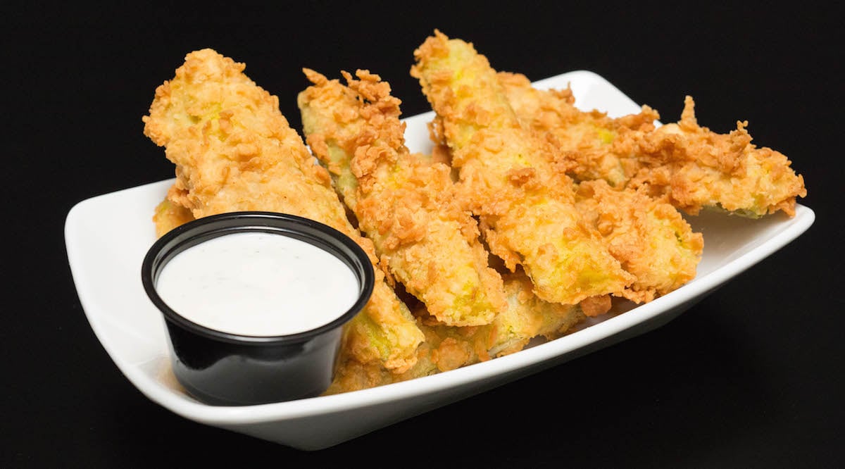 Chicken Fried Pickles next to ranch dipping sauce.